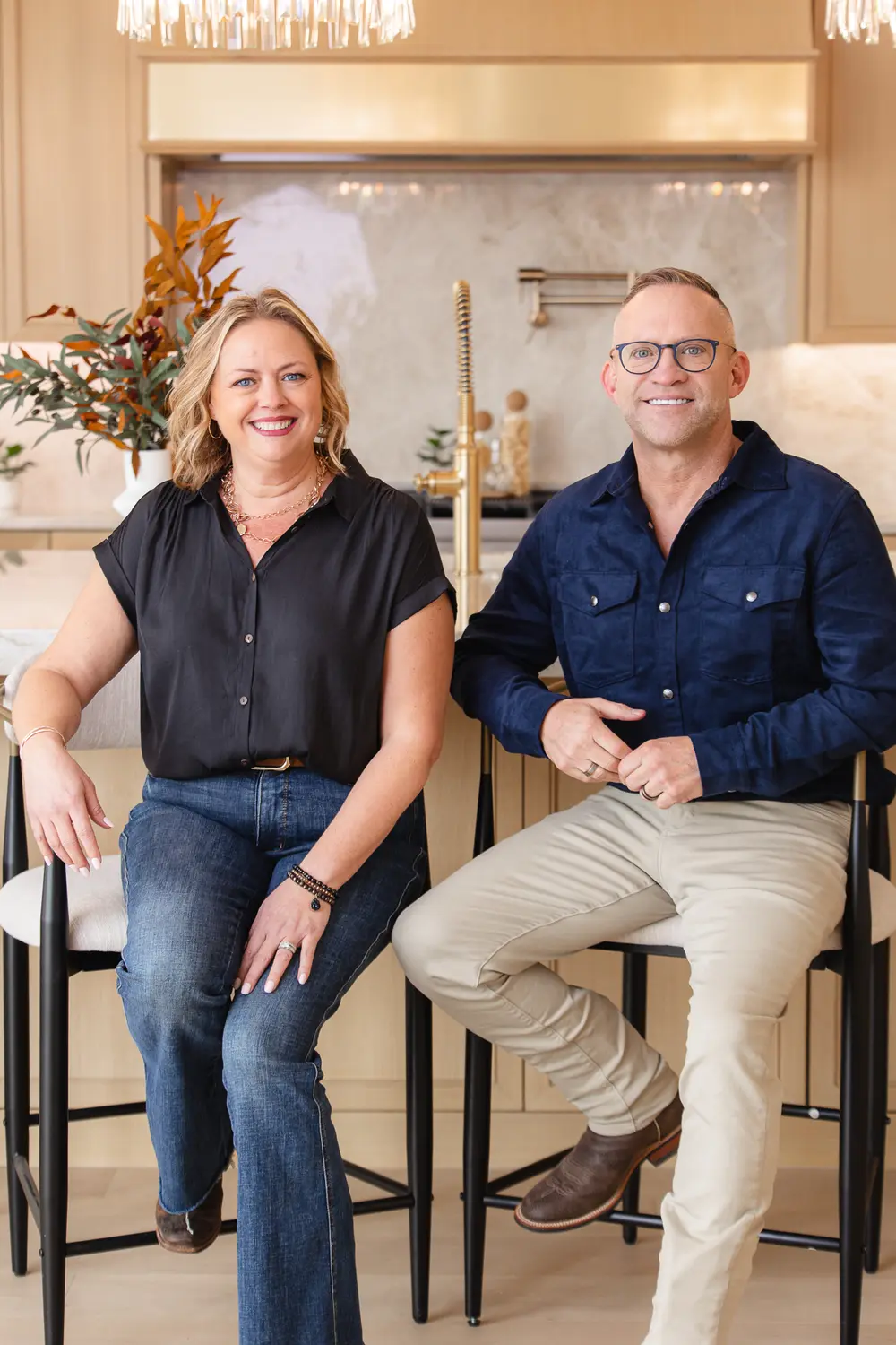 Two agents seated on kitchen bar stools for a team branding portrait