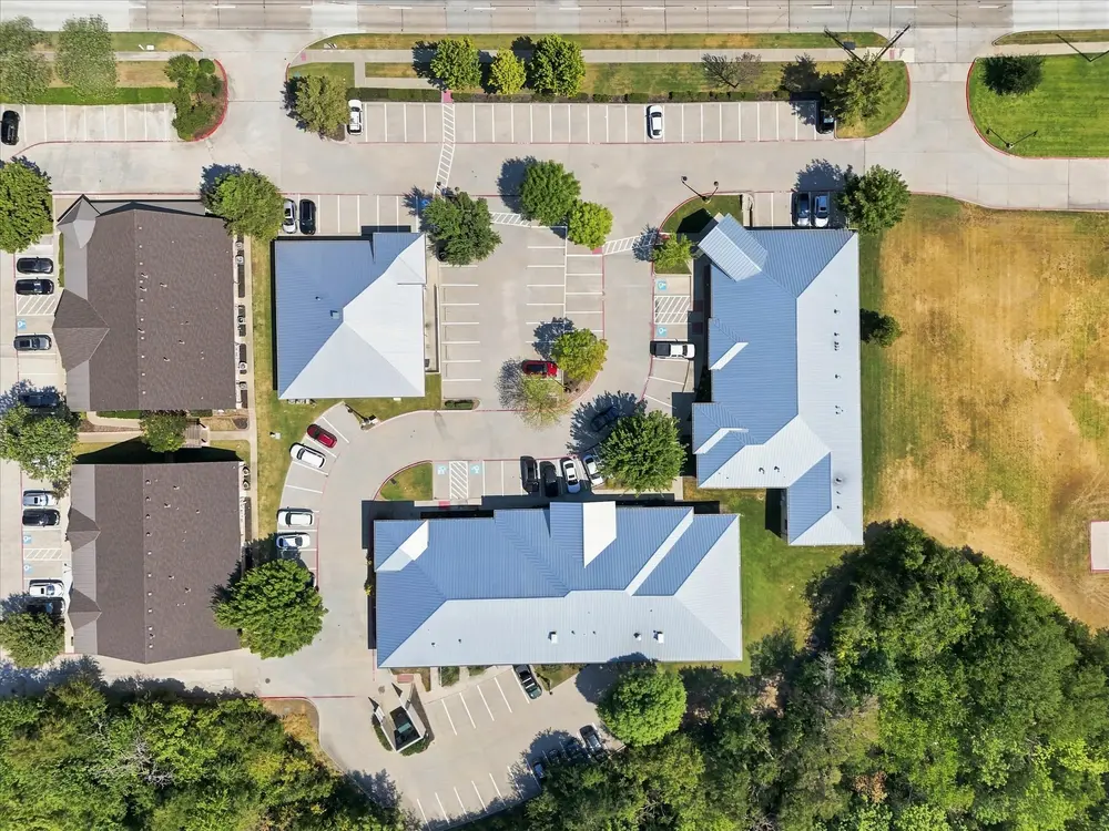 Straight-down aerial of an office park showing building footprints, parking and drive aisles
